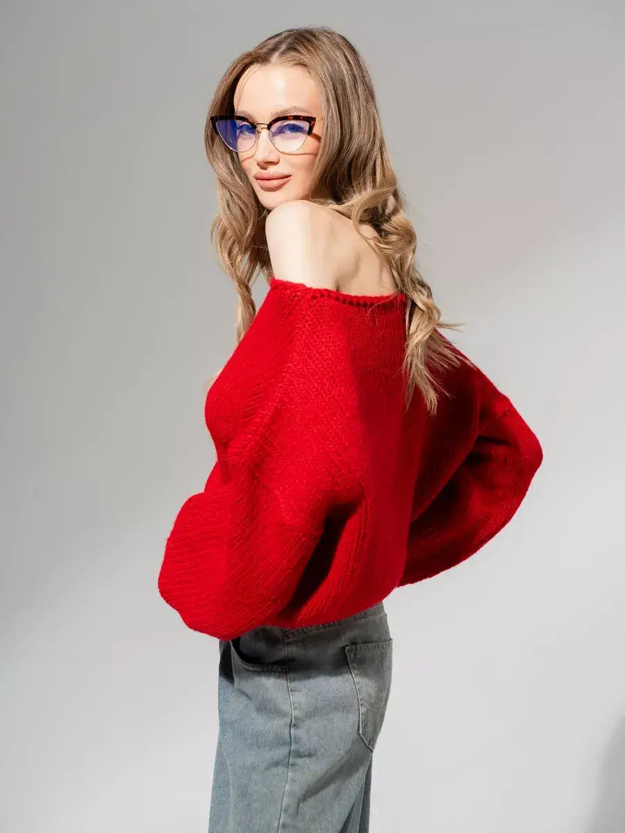 Model showcasing the Scarlet Sweater by Lauven, an oversized off-shoulder knit in deep red, exuding luxury and style.