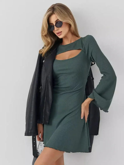 Woman wearing the Sculpt Flare mini dress in dark olive with bell sleeves, styled with a leather jacket and sunglasses.