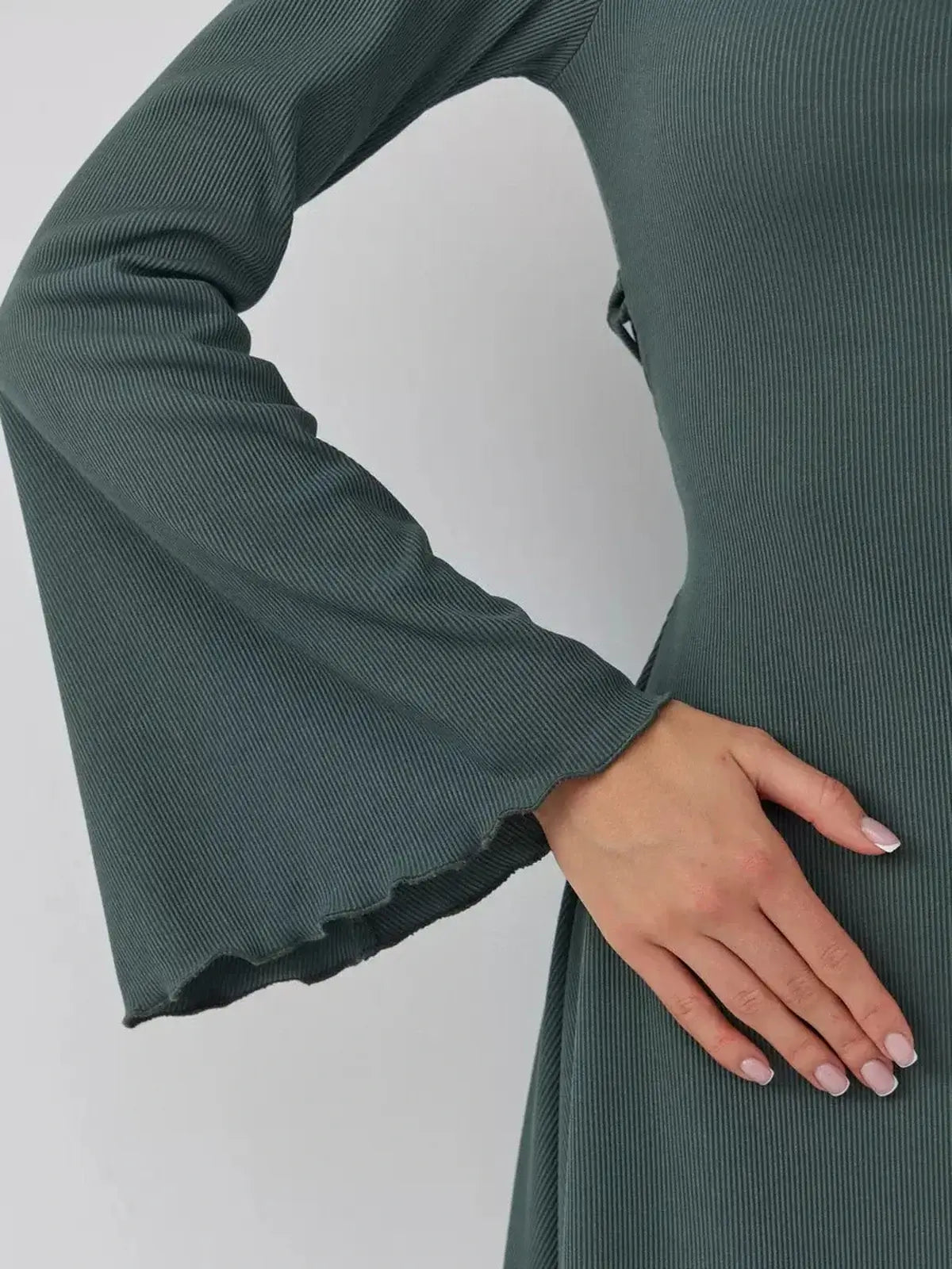 Close-up of dramatic bell sleeves on Lauven Sculpt Flare mini dress in dark olive.