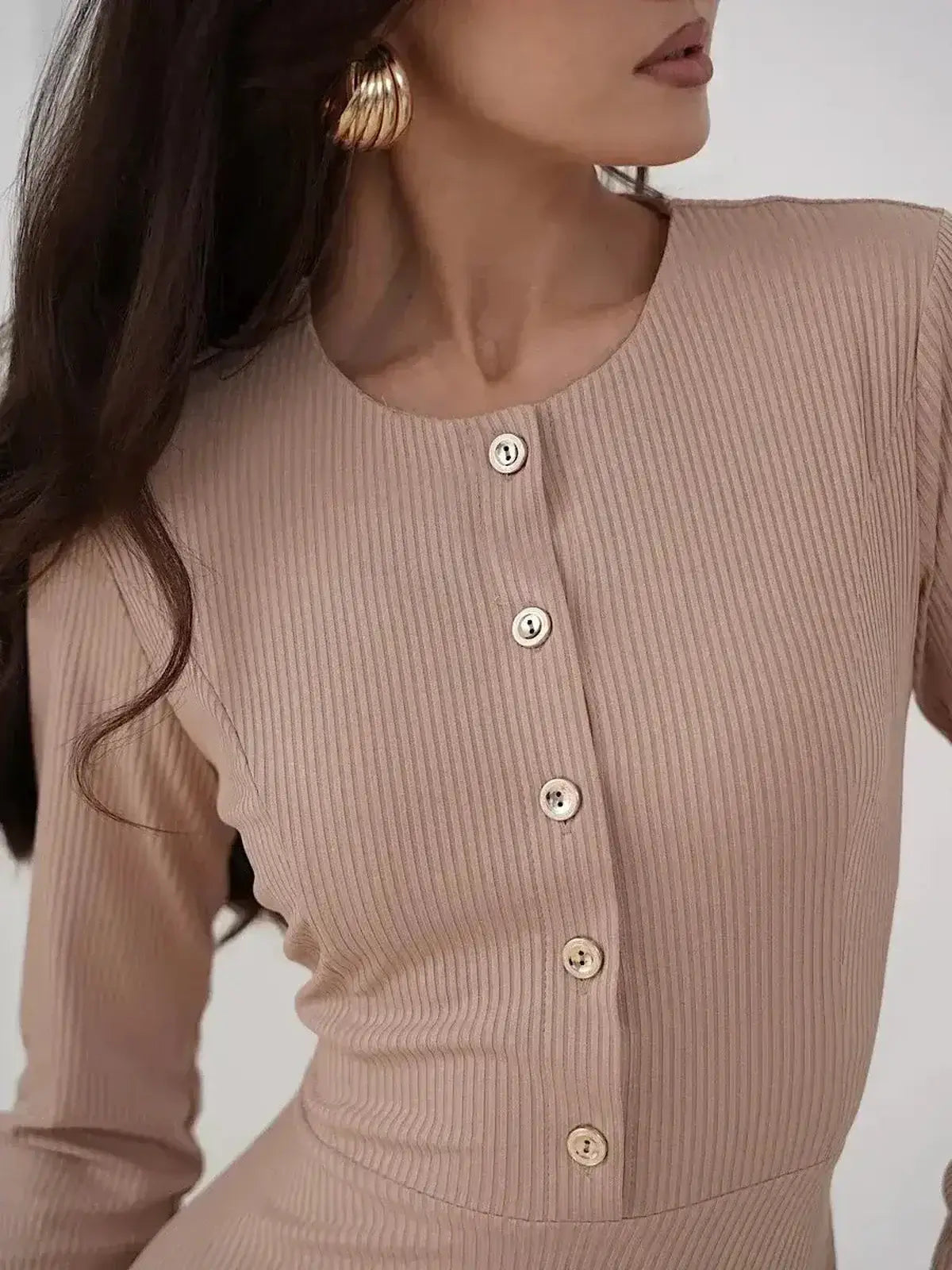 Close-up of a model wearing the Lauven Sculpted Ease Midi Dress, featuring ribbed knit, button accents, and a stylish beige color.