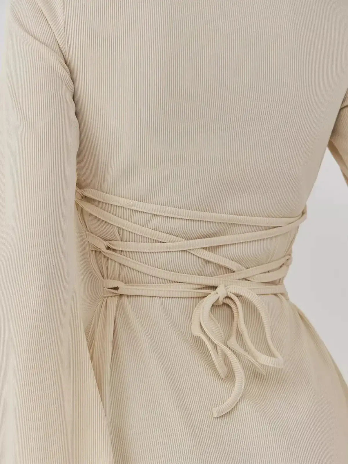 Back view of the Sculpted Grace mini dress by Lauven showcasing the elegant waist ties.