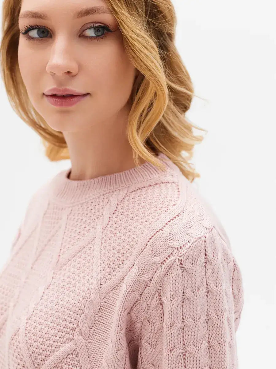 Seren Sweater by Lauven - Model wearing a powder pink wool-acrylic knitwear with cable knit details.