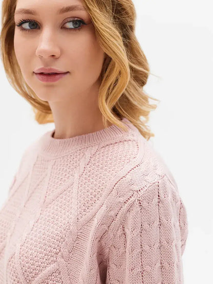 Seren Sweater by Lauven - Model wearing a powder pink wool-acrylic knitwear with cable knit details.