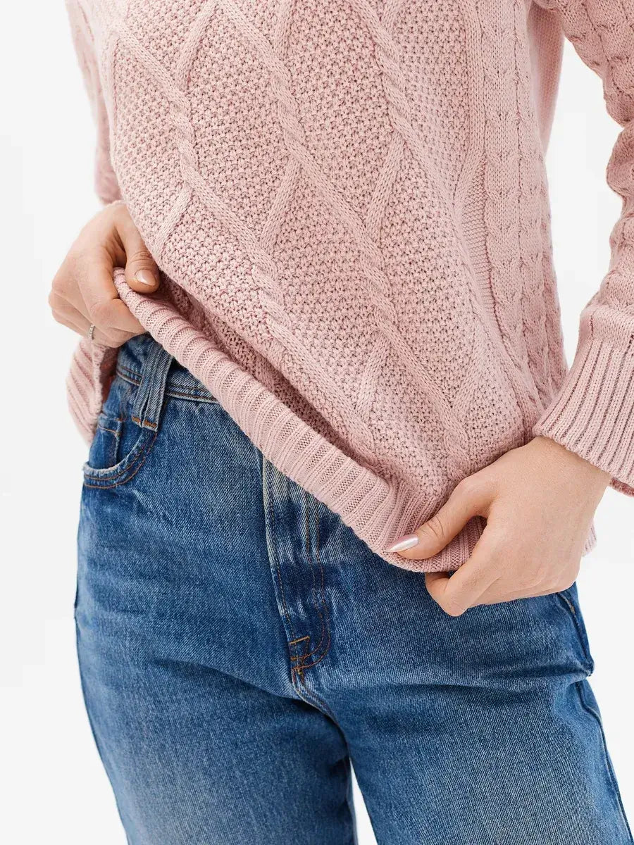 Seren Sweater by Lauven in powder pink wool-acrylic with cable knit sleeves, styled with high-waisted jeans.