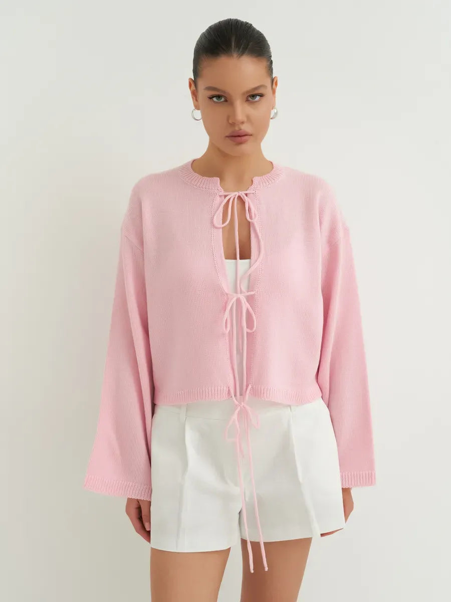 Model wearing Serena Cardigan by Lauven in soft powder pink, showcasing stylish lightweight summer knitwear.