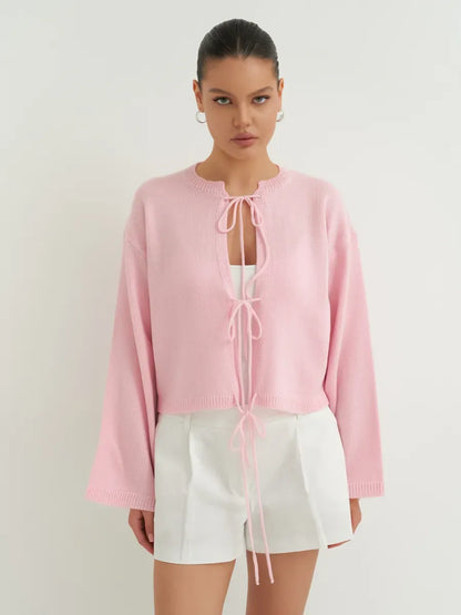 Model wearing Serena Cardigan by Lauven in soft powder pink, showcasing stylish lightweight summer knitwear.