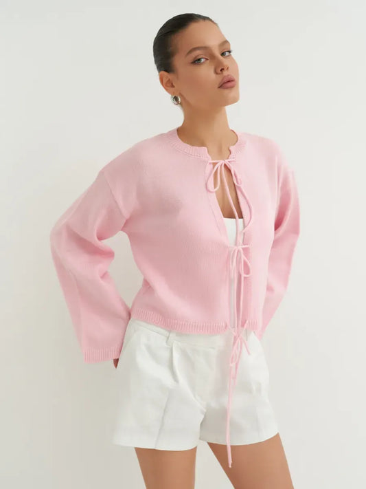 Serena Cardigan by Lauven in soft powder pink on model, styled for summer fashion, lightweight knitwear.