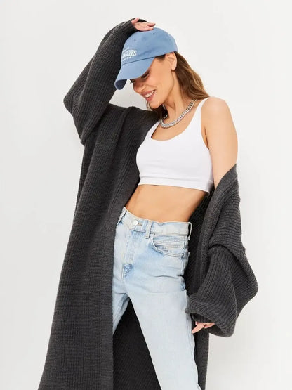 Shadow Cardigan worn by a stylish woman, featuring an oversized knitwear coat in deep gray.