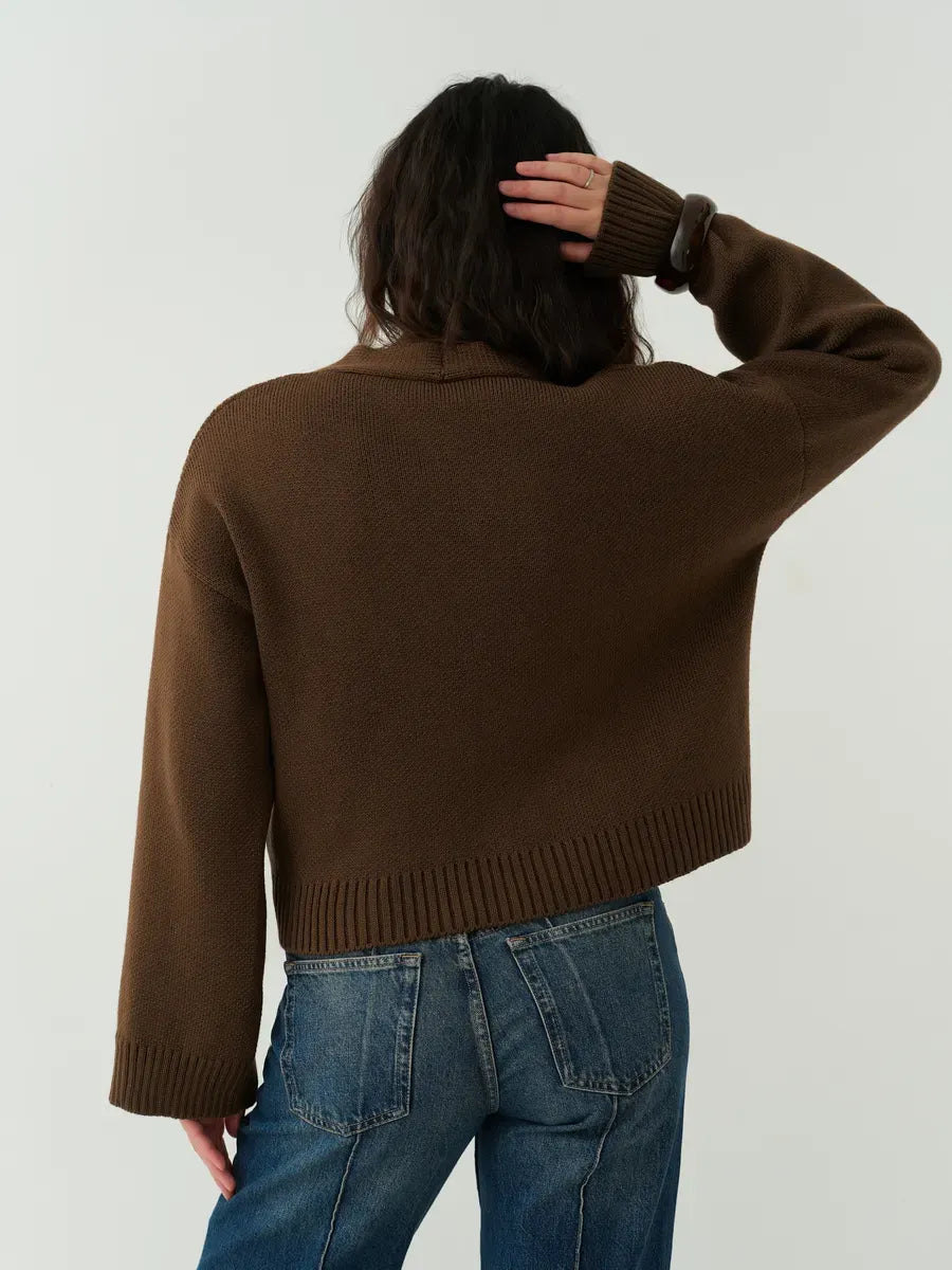 Woman wearing the Siena Cardigan, a cropped chocolate brown knit with relaxed fit and wide sleeves, by Lauven.