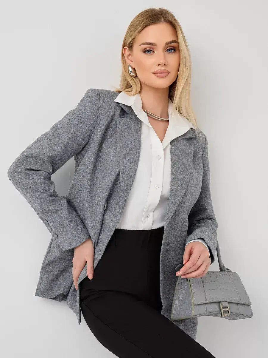 Model wearing a Silverstone Blazer by Lauven, an oversized gray tailored jacket, styled with a white blouse.