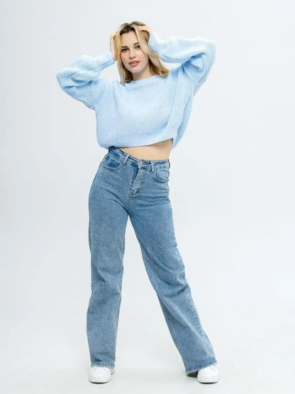 Fashion model wearing Skylar Pullover cropped knit in sky blue with relaxed blue jeans from Lauven.