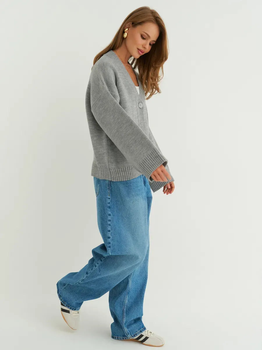 Stylish woman in oversized Slate Cardigan by Lauven, featuring button closure and wide sleeves for chic comfort.