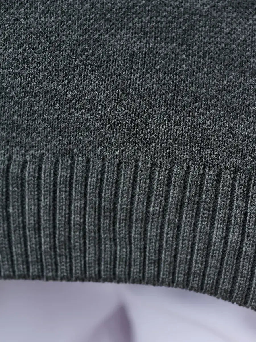 Slate Pullover by Lauven, showing the ribbed hem detail of an oversized cropped women’s sweater in dark gray.