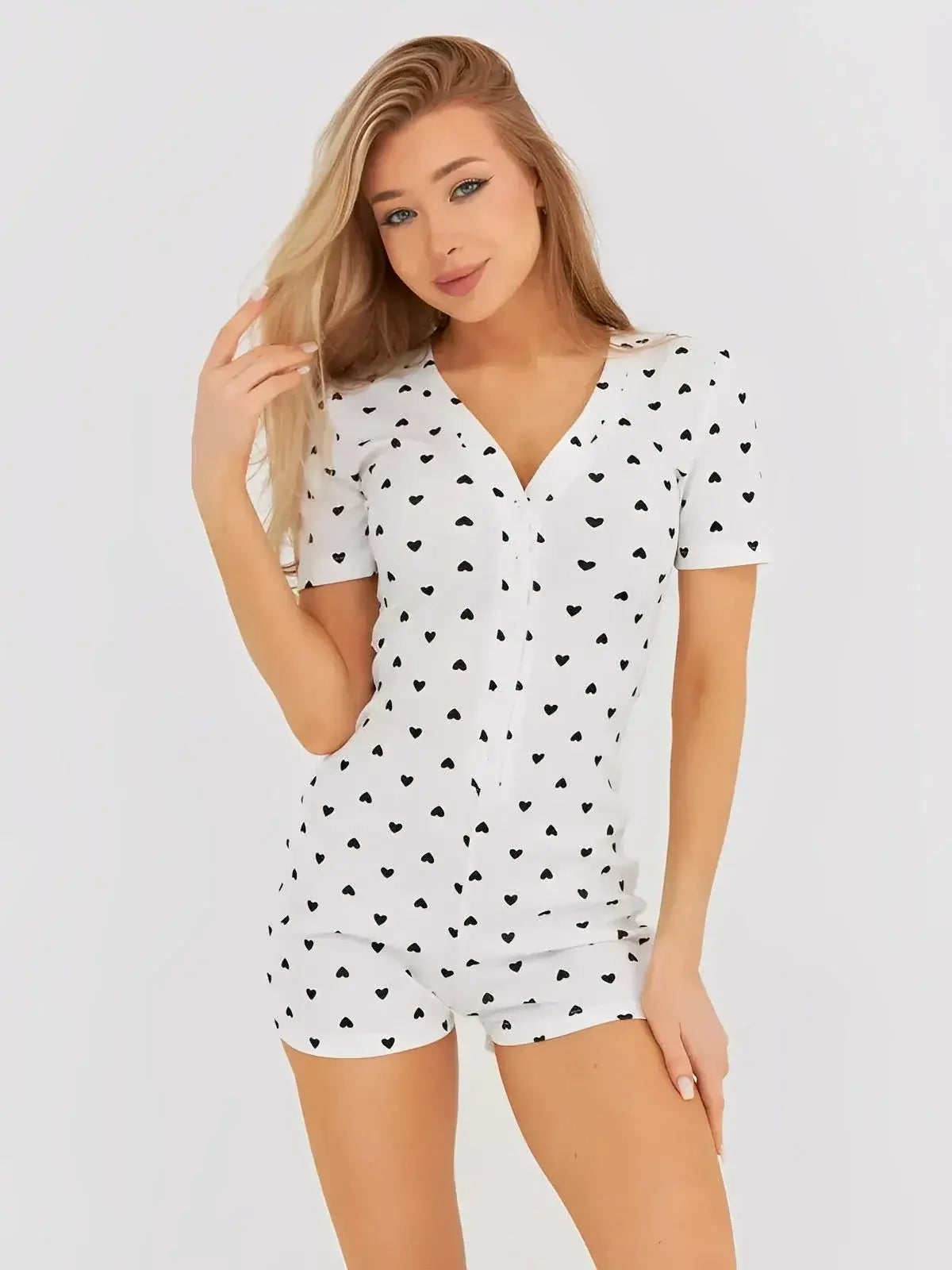 Model wearing Lauven Sweetheart Playsuit featuring white and black heart print in a cozy, figure-hugging design.