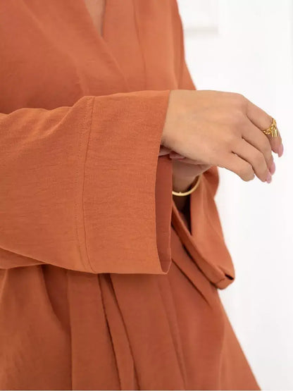 Terracotta Suit Set by Lauven showcasing oversized sleeves and warm brown fabric.