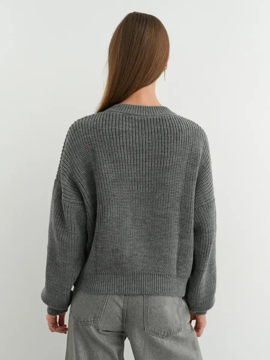 Vega Sweater by Lauven in grey, showcasing an oversized knit design with a relaxed silhouette.
