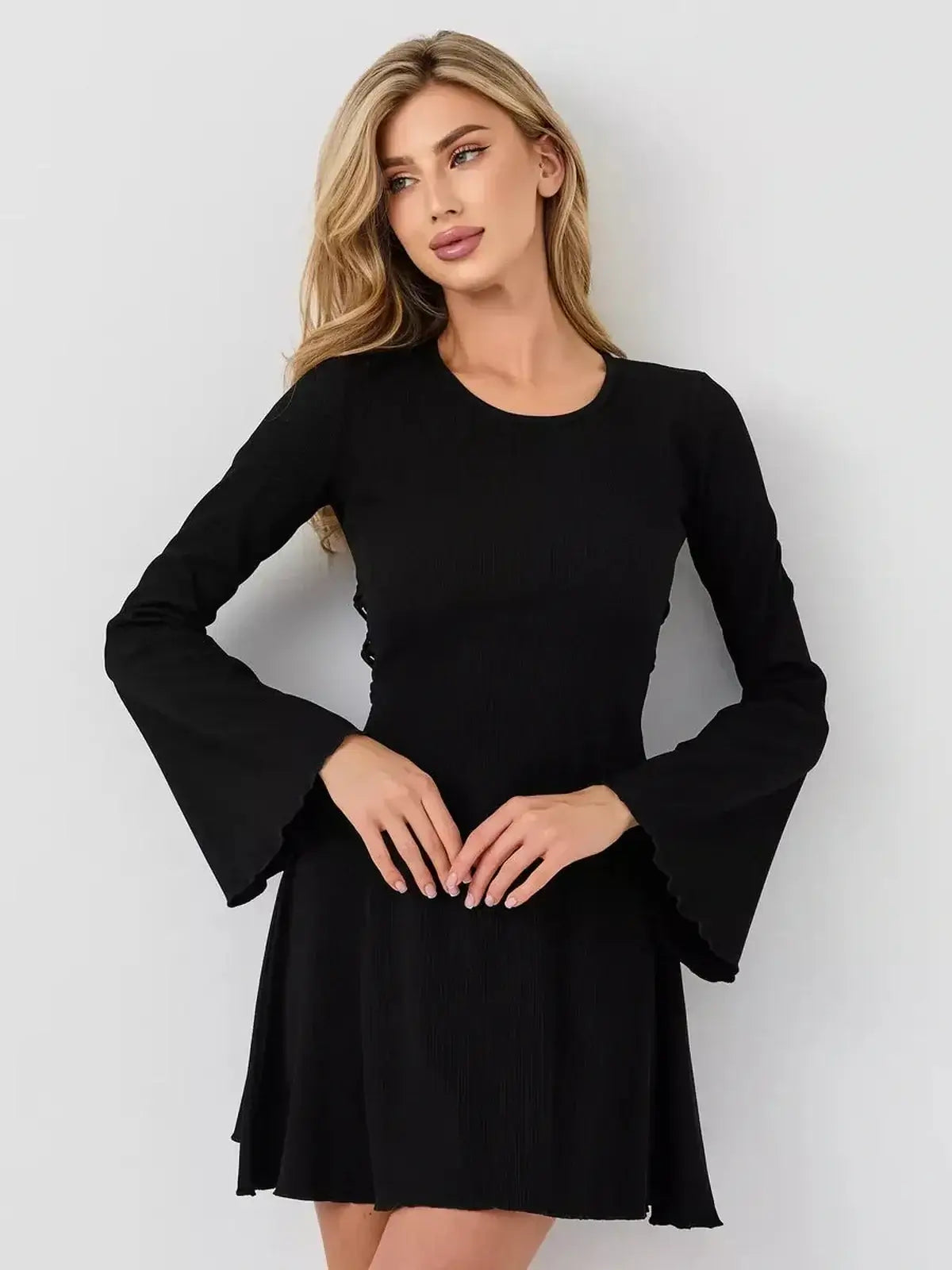 Velvet Hour by Lauven: black sculpting mini dress with flared cuffs and U-neckline, combining luxury and modern design.