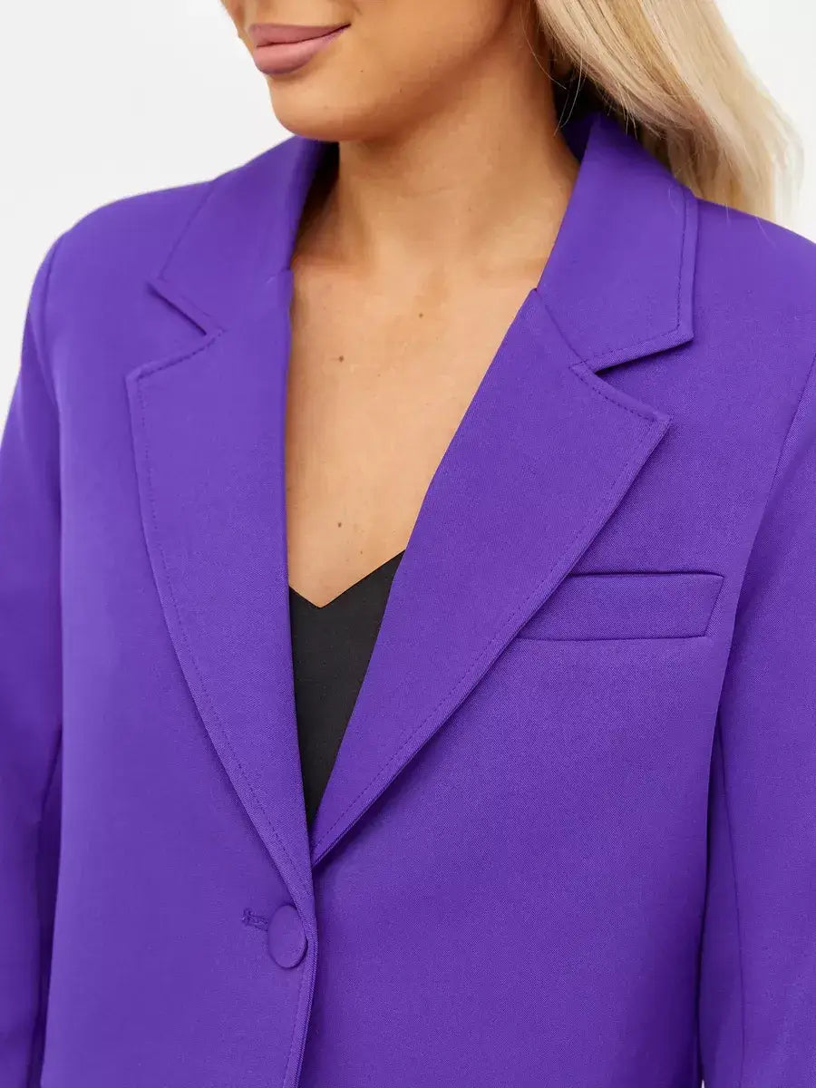 Model showcasing a Violet Blazer by Lauven, featuring a chic cropped design in bold purple.