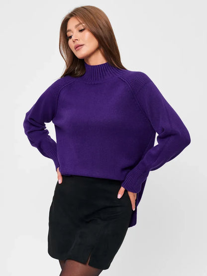 Stylish woman wearing a Violet Sweater by Lauven, featuring an oversized fit and high neck in deep purple.