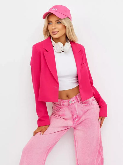 Stylish woman wearing a Magenta Blazer by Lauven, paired with a white top and pink jeans for a bold, fashionable look.