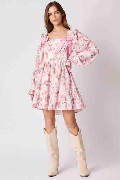 Lila Mini Dress for women in pink floral print with bow accents, perfect for summer or wedding guest attire.