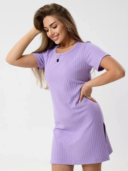 Model wearing the Lilac Ripple mini dress by Lauven, showcasing its ribbed knit design and flattering fit.
