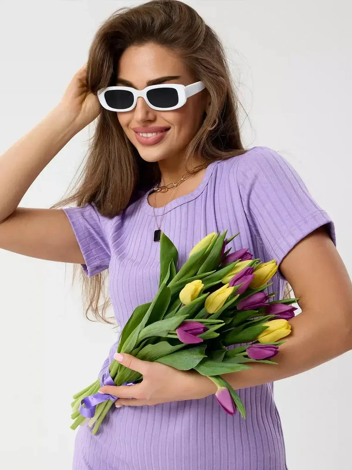 Lilac Ripple mini dress by Lauven, featuring a ribbed texture and short sleeves, paired with colorful tulips.
