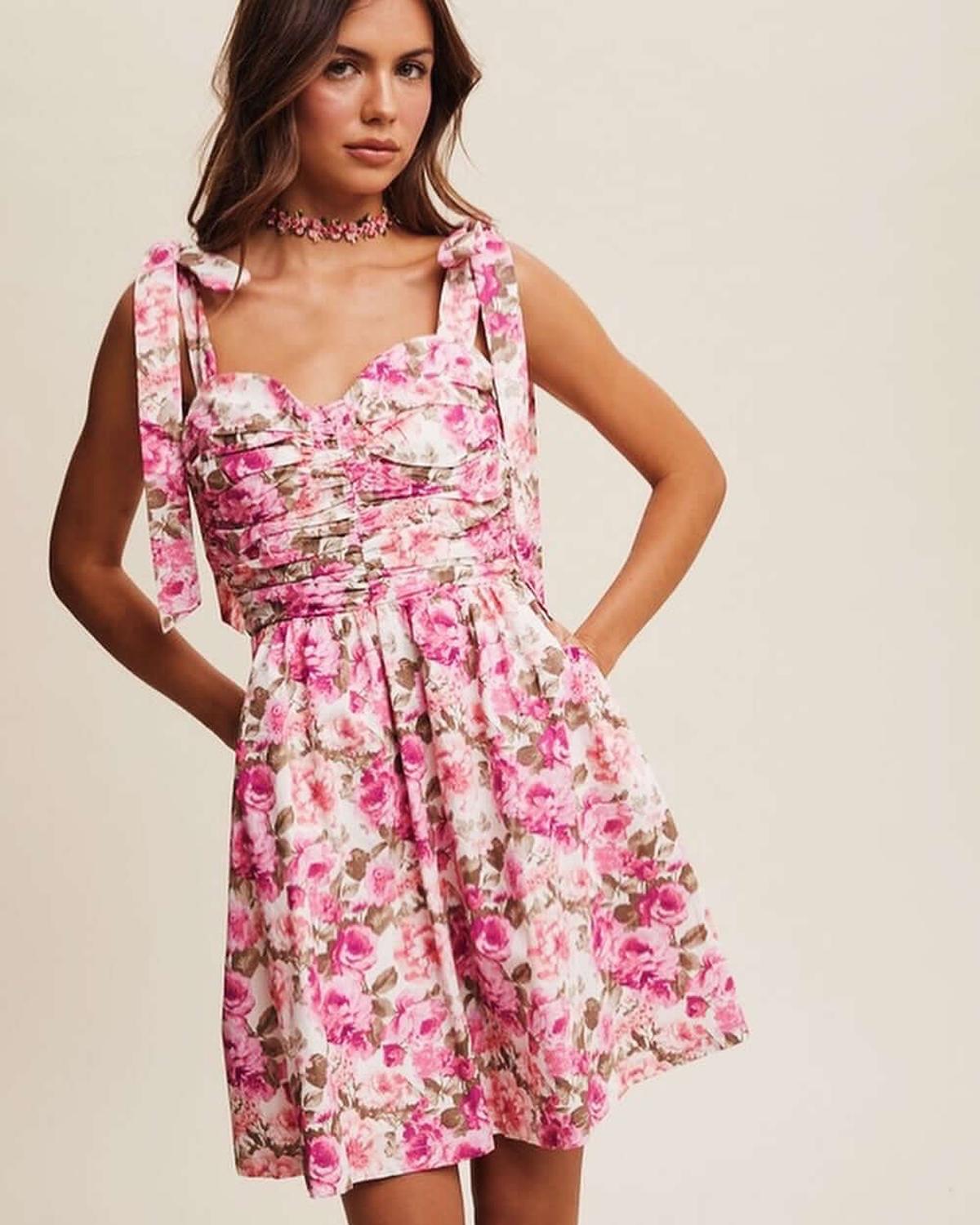 Lilia Mini Dress featuring a vibrant floral print and playful charm, perfect for summer parties and casual occasions.