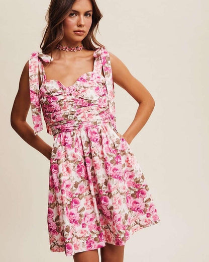 Lilia Mini Dress featuring a vibrant floral print and playful charm, perfect for summer parties and casual occasions.