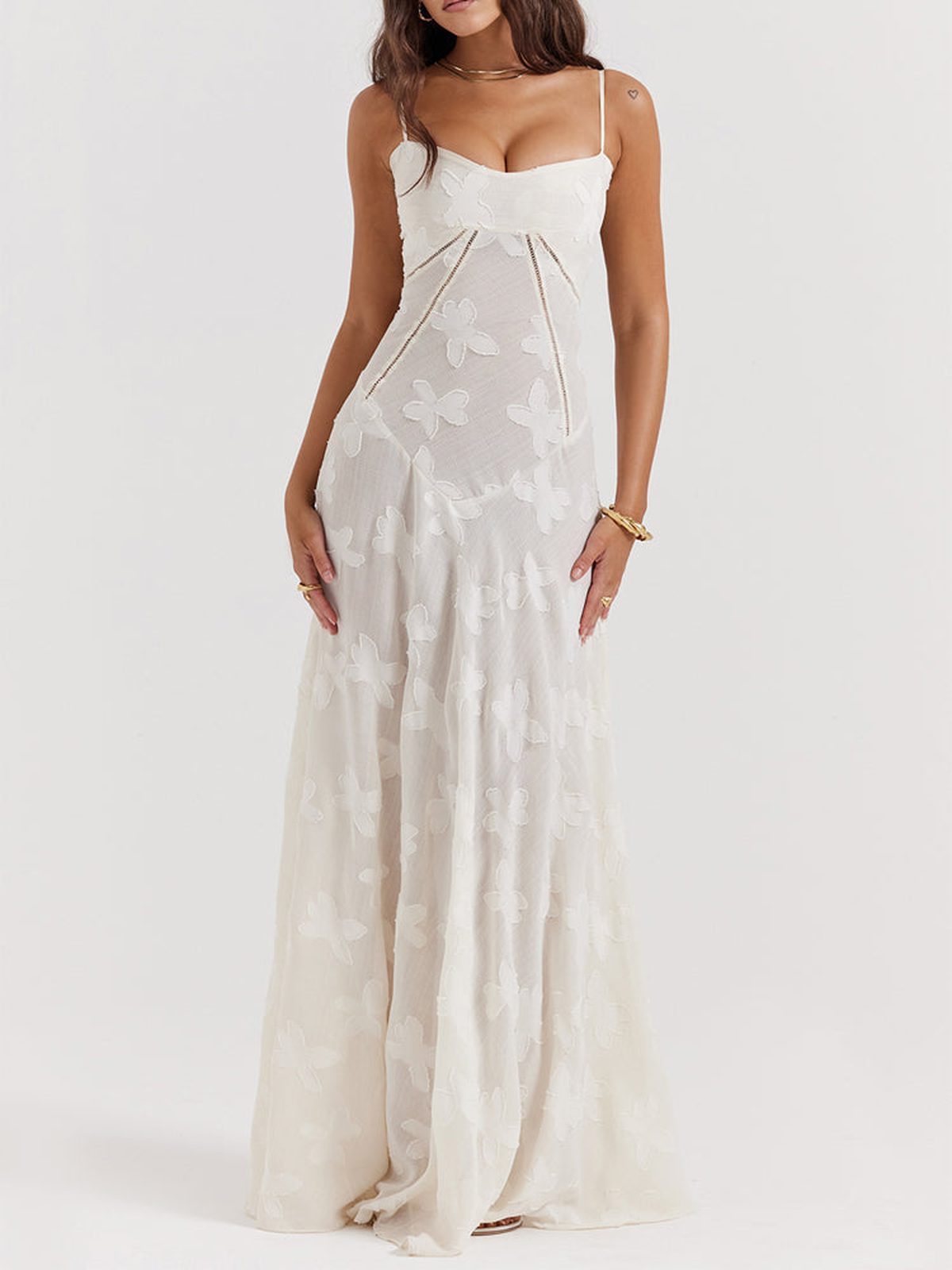 Elegant white maxi dress with intricate lace detailing and delicate spaghetti straps, perfect for weddings and summer events.