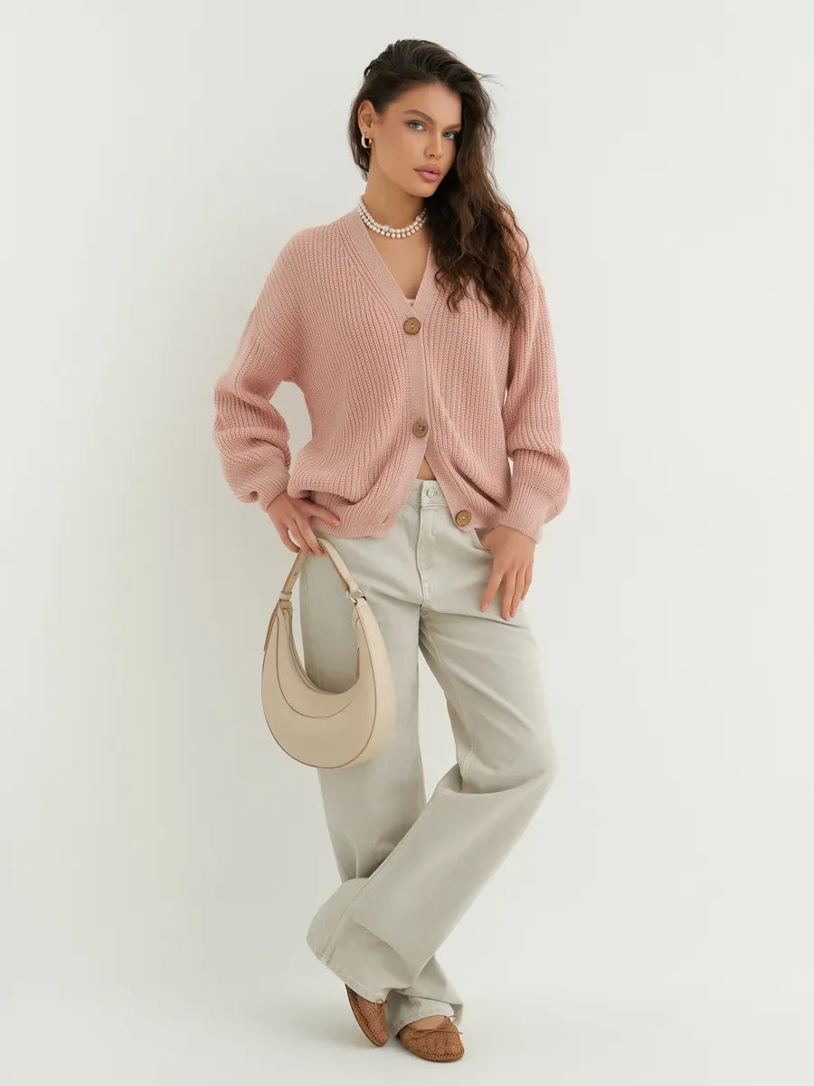 Liora Cardigan by Lauven, soft powder pink oversized knitwear paired with casual light trousers.