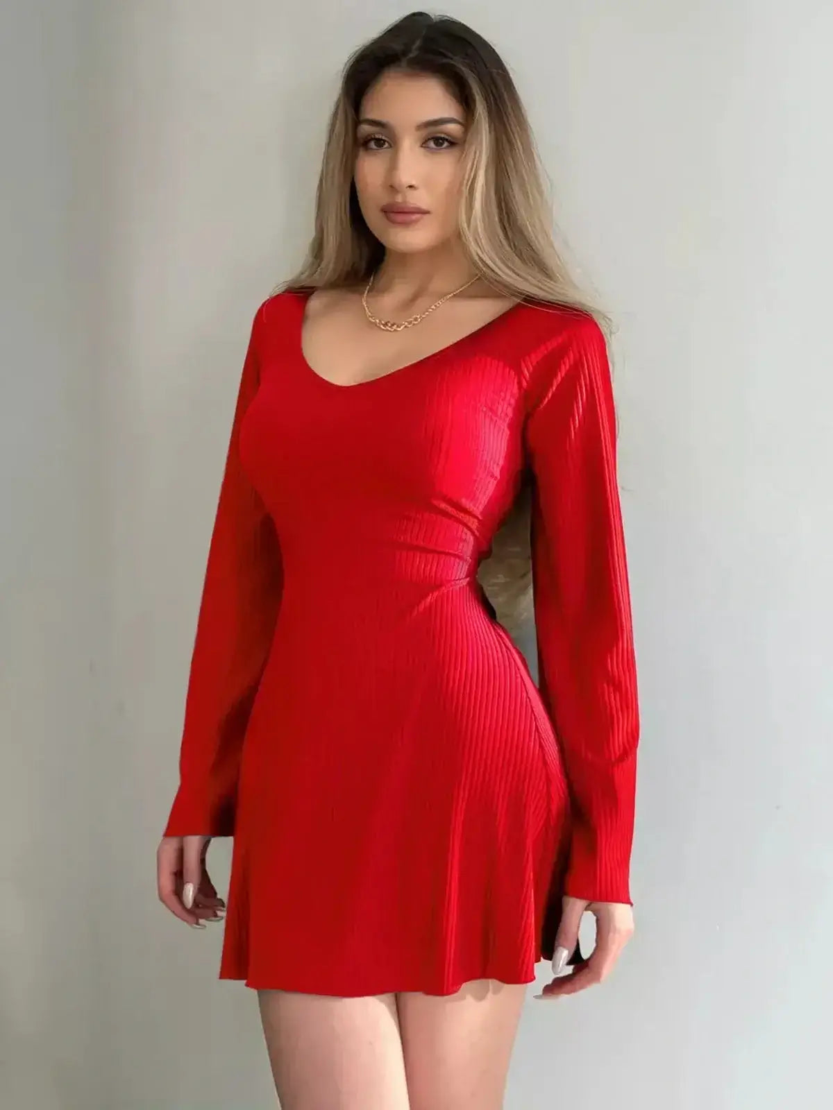Model wearing a red Luna Flare Mini Dress with bell sleeves, designed for summer events and parties.