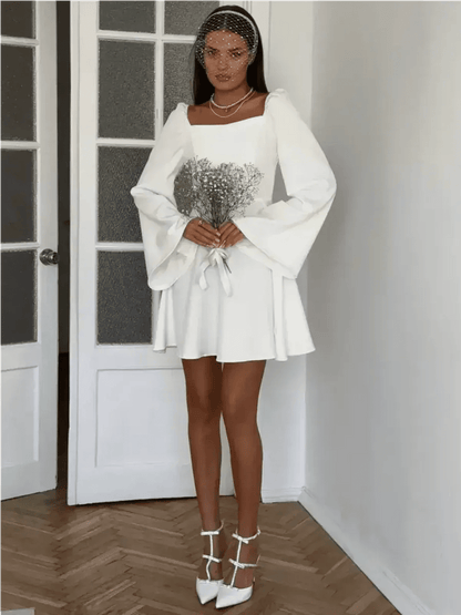 Luna Whisper white mini dress with voluminous sleeves, perfect for weddings, graduation, and formal occasions.
