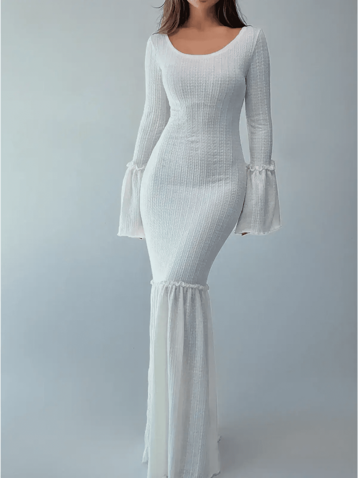Elegant woman wearing a Lustre Maxi Dress with bell sleeves and flounced hem in white, showcasing a sculpted silhouette.