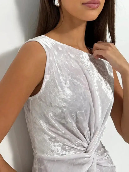 Close-up of a model wearing the Lustre Twist Maxi Dress featuring elegant velvet fabric and architectural twist detail.