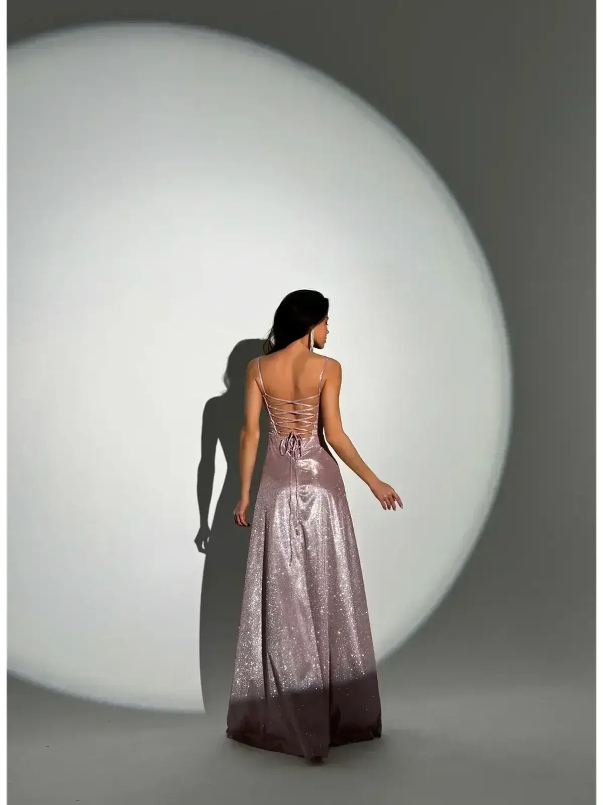 Elegant back view of the Lustrous Spell Maxi Dress in blush-pink, showcasing its sculpted bodice and flowing hemline.
