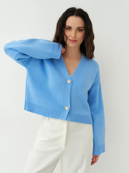 Lyra Cardigan by Lauven: Cropped blue knit cardigan with heart buttons and wide sleeves.