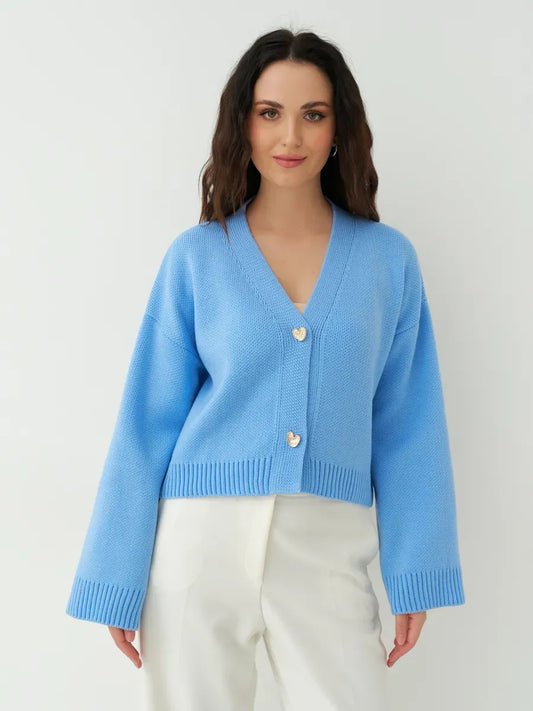 Lyra Cardigan by Lauven in cropped blue knit with heart buttons, featuring wide sleeves and modern femininity.