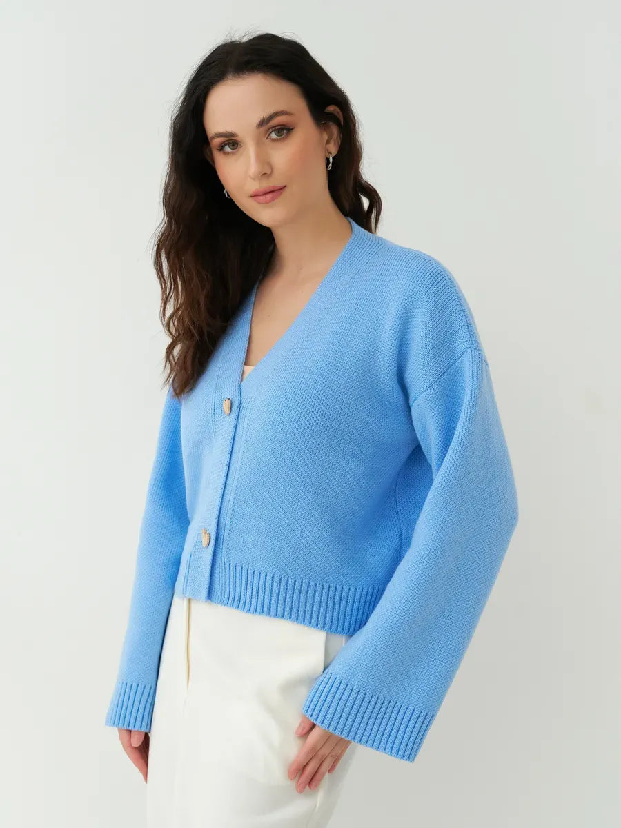 Lyra Cardigan by Lauven, cropped blue knit with heart buttons, showcasing modern femininity and relaxed elegance.