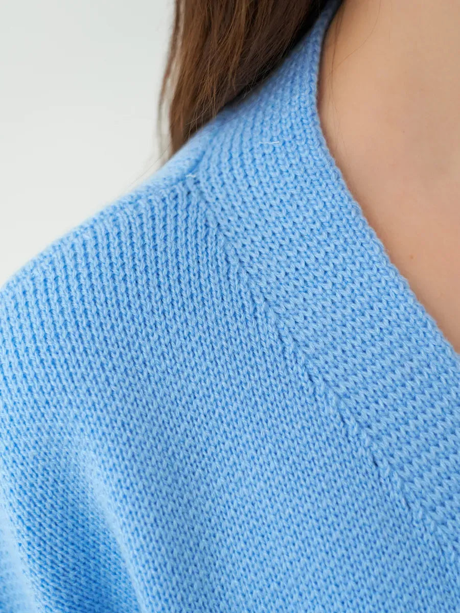 Lyra Cardigan detail in sky blue knit by Lauven, showcasing the textured fabric and relaxed neckline.