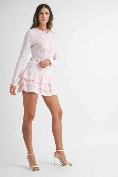 Model wearing the Lyra Mini Dress, a ruffle knit set in pink, ideal for summer dresses and wedding guest outfits.