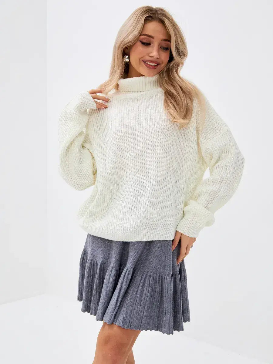 Lyra Sweater by Lauven - Oversized Knit with High Neck in Ivory, styled with a flared gray skirt.