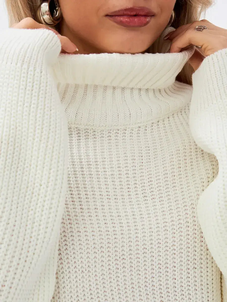 Close-up of the Lyra Sweater by Lauven, featuring an oversized knit and high neck in soft ivory.
