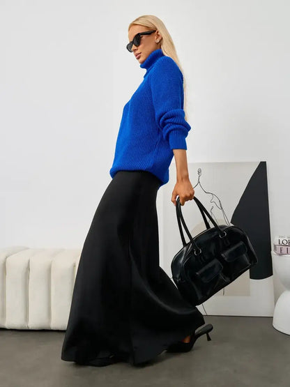 Lyra Sweater by Lauven in blue worn with a long black skirt, showcasing turtleneck elegance and relaxed fit.