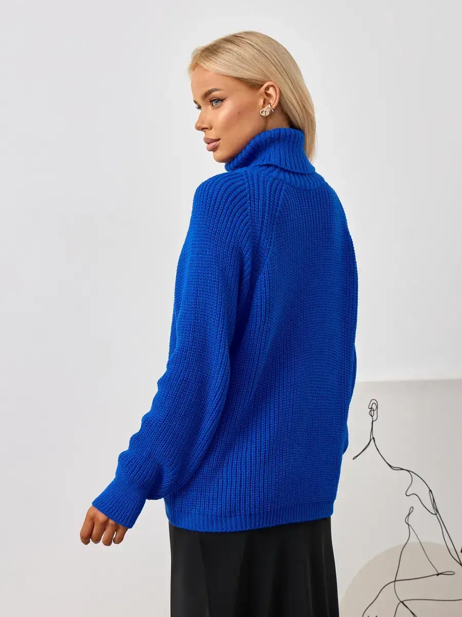 Woman wearing the Lyra Sweater by Lauven, showcasing its oversized knit and turtleneck design in vibrant blue.