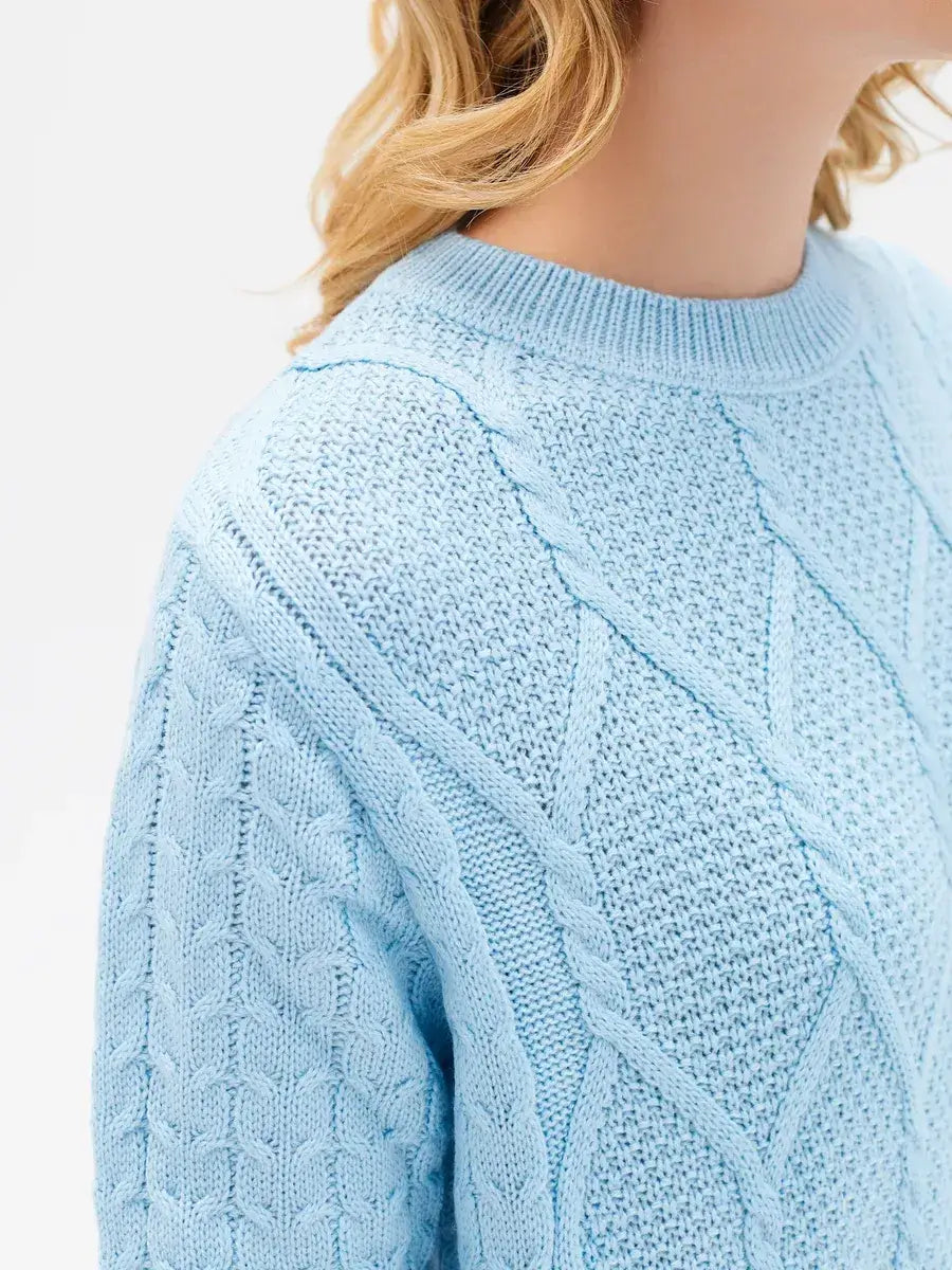 Lyra Sweater from Lauven in light blue cable knit, showcasing modern elegance and comfort.