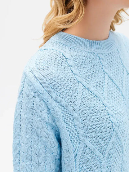 Lyra Sweater from Lauven in light blue cable knit, showcasing modern elegance and comfort.