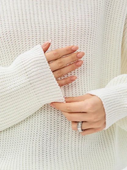 Lyra Sweater by Lauven, showcasing soft ivory oversized knit with high neck and detailed sleeve design.