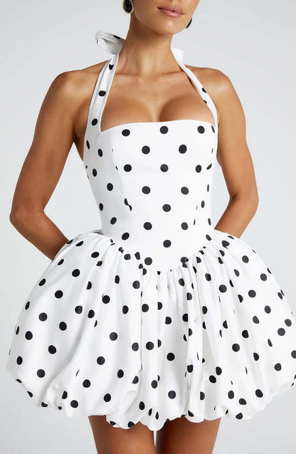 Mae Mini Dress featuring a halter neckline with black polka dots, perfect for summer parties and casual outings.