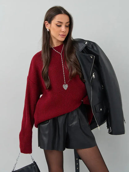 Maribel Sweater by Lauven in oversized burgundy knit, styled with a black leather jacket and shorts.
